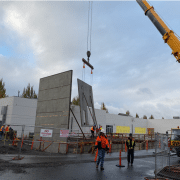 crane building lowering new wall of Training Center